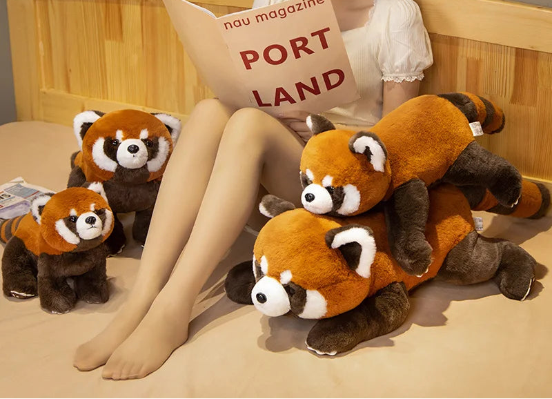 Woman reading a magazine with stuffed red panda toys on a bed