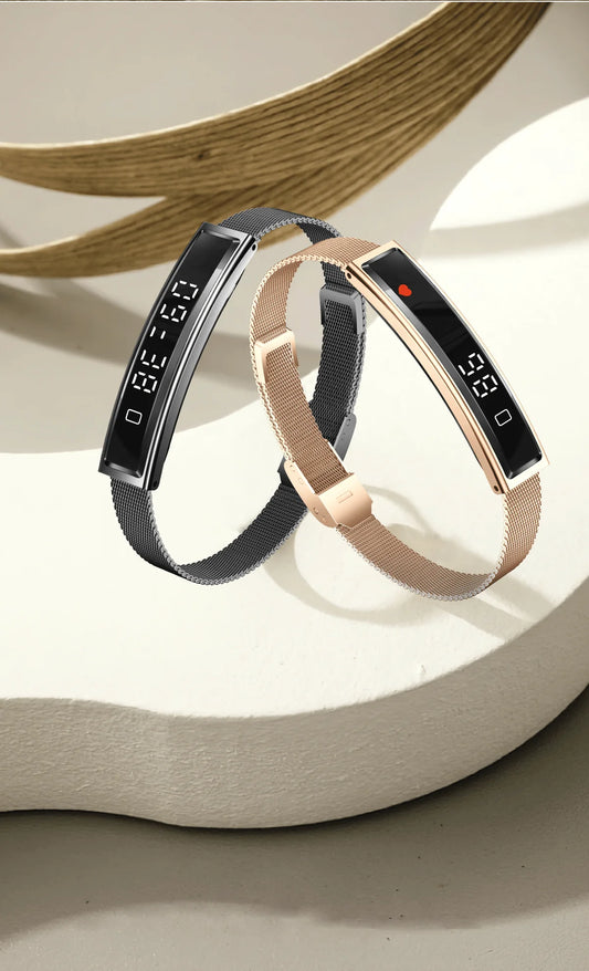 Smart fitness bracelet in gold and white, showing slim touchscreen and silicone/mesh straps.