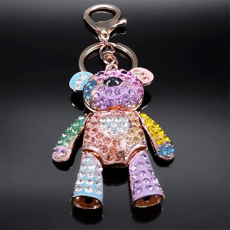 Colorful teddy bear keychain with rhinestones on a black background