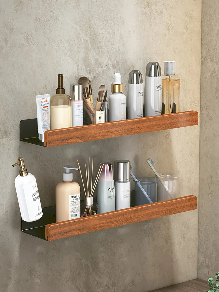 Wooden shelves with various bathroom products against a neutral wall.