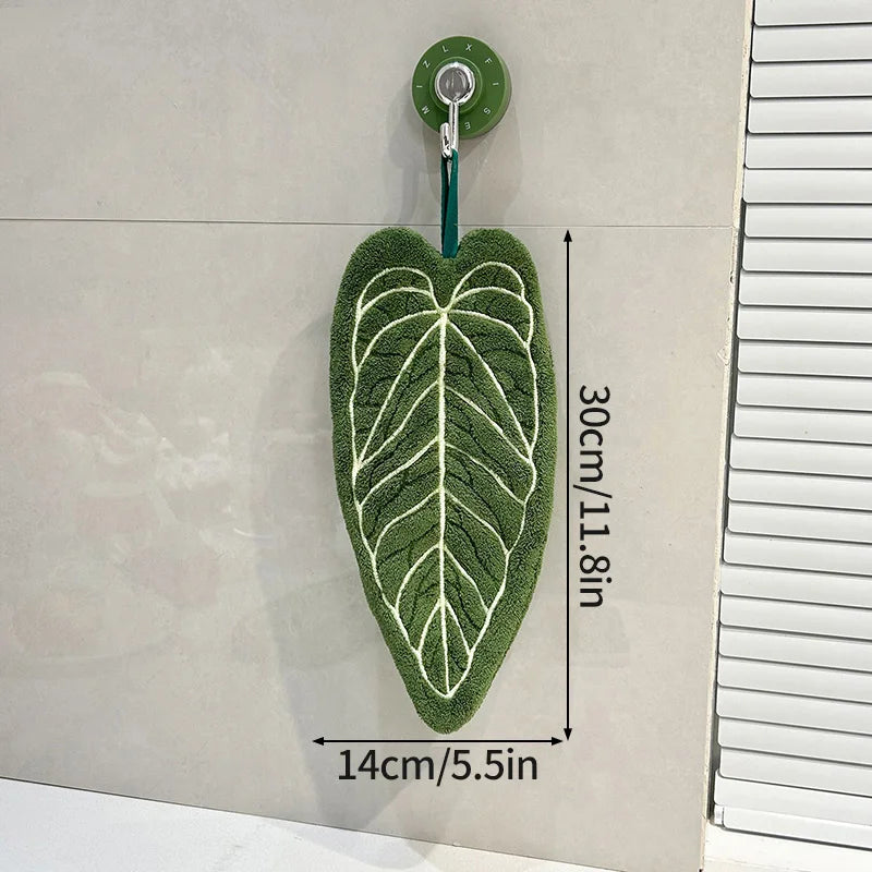 Green leaf-shaped mat with a hook on a white background