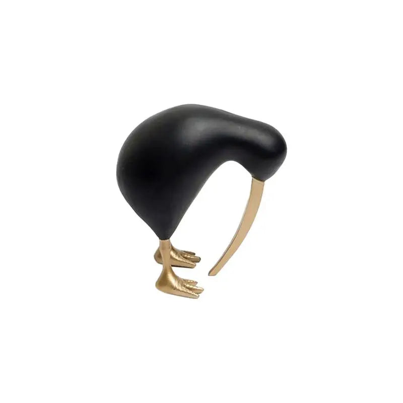 Black modern bird statue with gold feet and beak on a white background