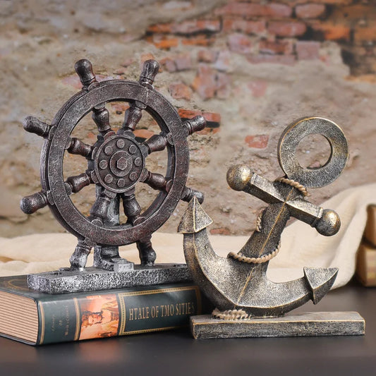 Decorative ship's wheel and anchor on a book with a rustic background