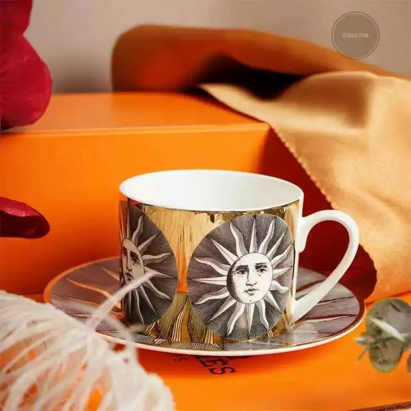 Teacup and saucer with sun design on an orange surface