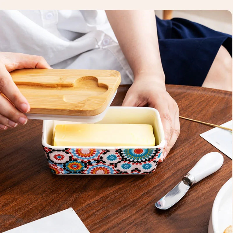 Butter dish with a wooden lid on a wooden table