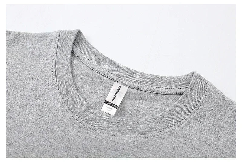Gray t-shirt collar with a visible brand label on a light gray background
