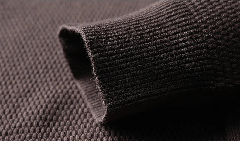 Close-up of a cuff on a textured brown fabric  