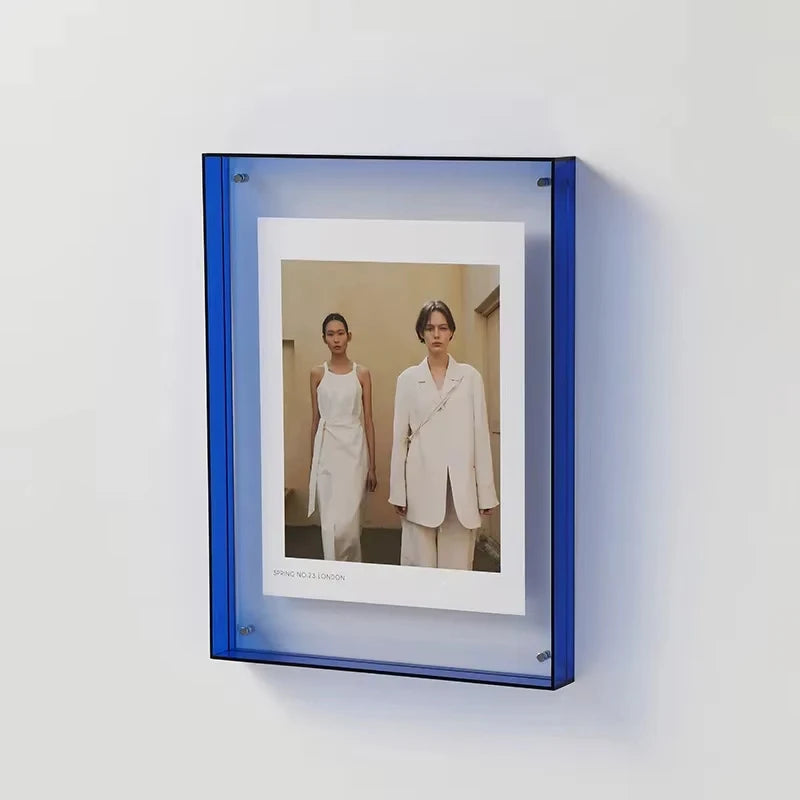Cobalt Acrylic Photo Frame with a photo of two people in white suits on a white wall