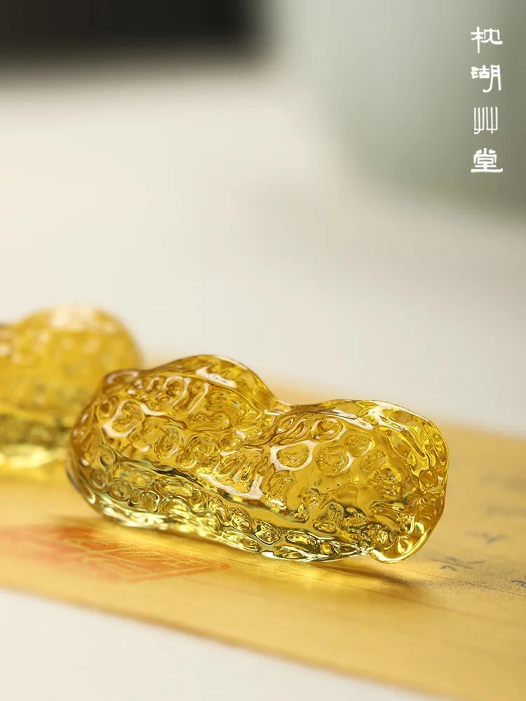 Decorative peanut with intricate patterns on a reflective surface