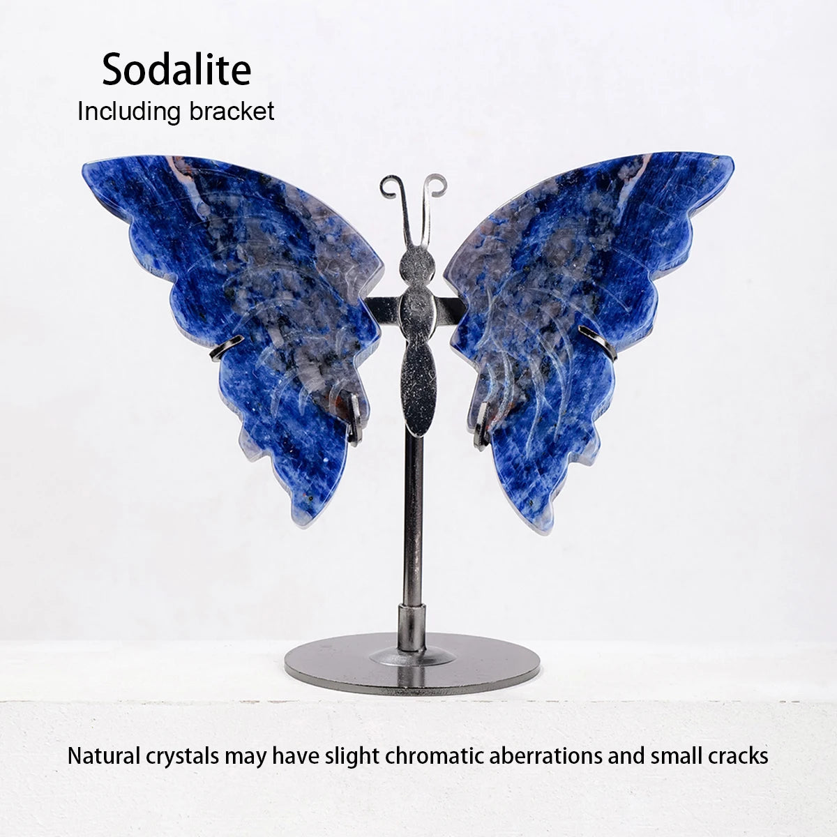 Butterfly-shaped sodalite crystal on a stand with text about natural crystals.