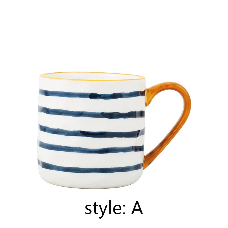 Mug with blue and white striped design and orange handle on a white background