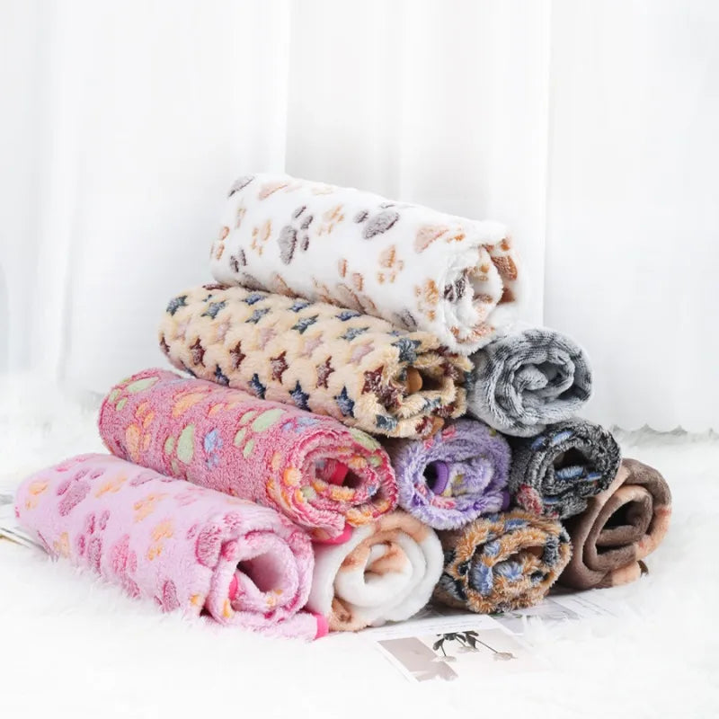 Stack of colorful folded pet blankets on a white background
