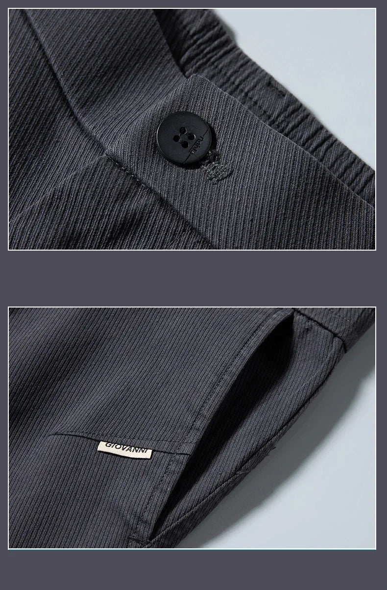 Close-up of a dark gray jacket with a button and brand label on a light blue background