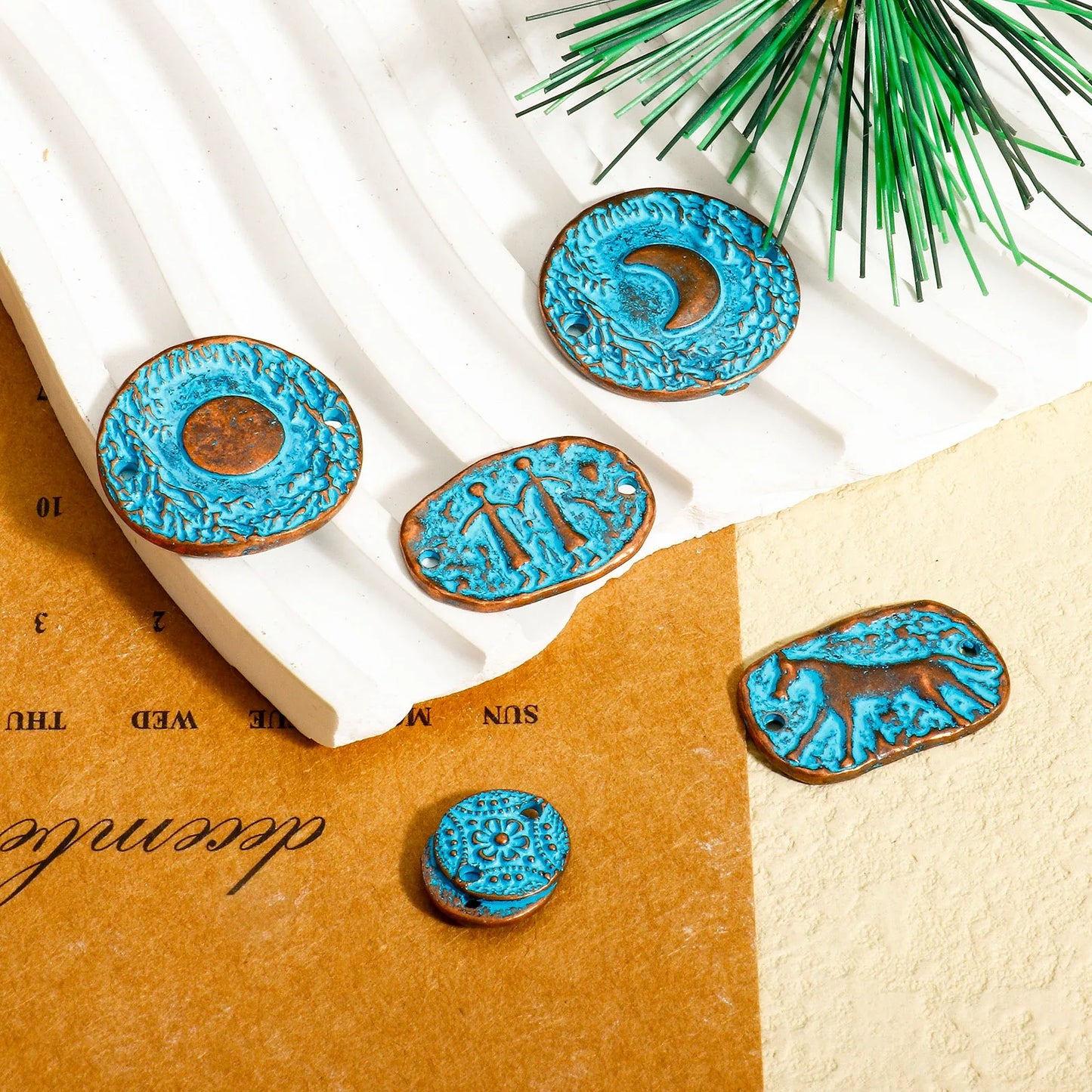 Blue ceramic donut-shaped items on a textured surface with greenery