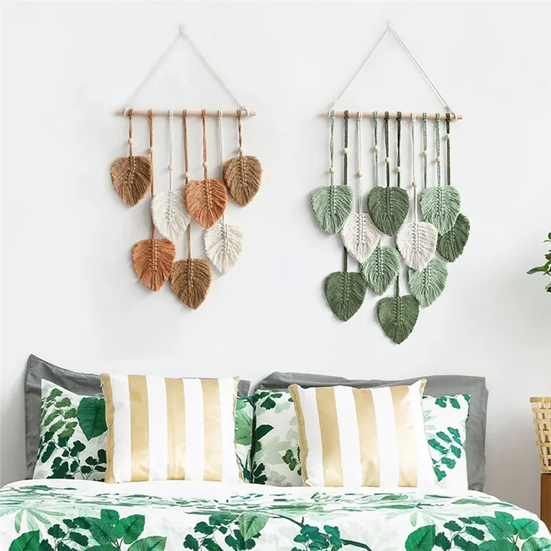Decorative wall hangings with leaf patterns above a bed with matching bedding.