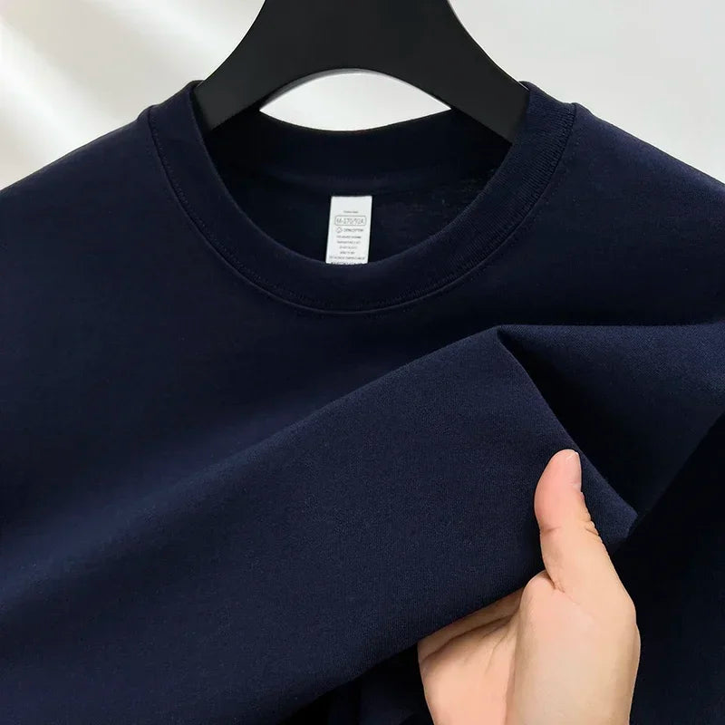 Navy blue sweatshirt on a hanger with a white label.