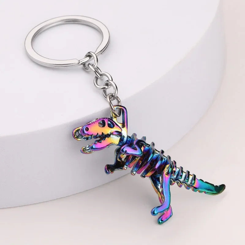 Metallic dinosaur keychain on a white background