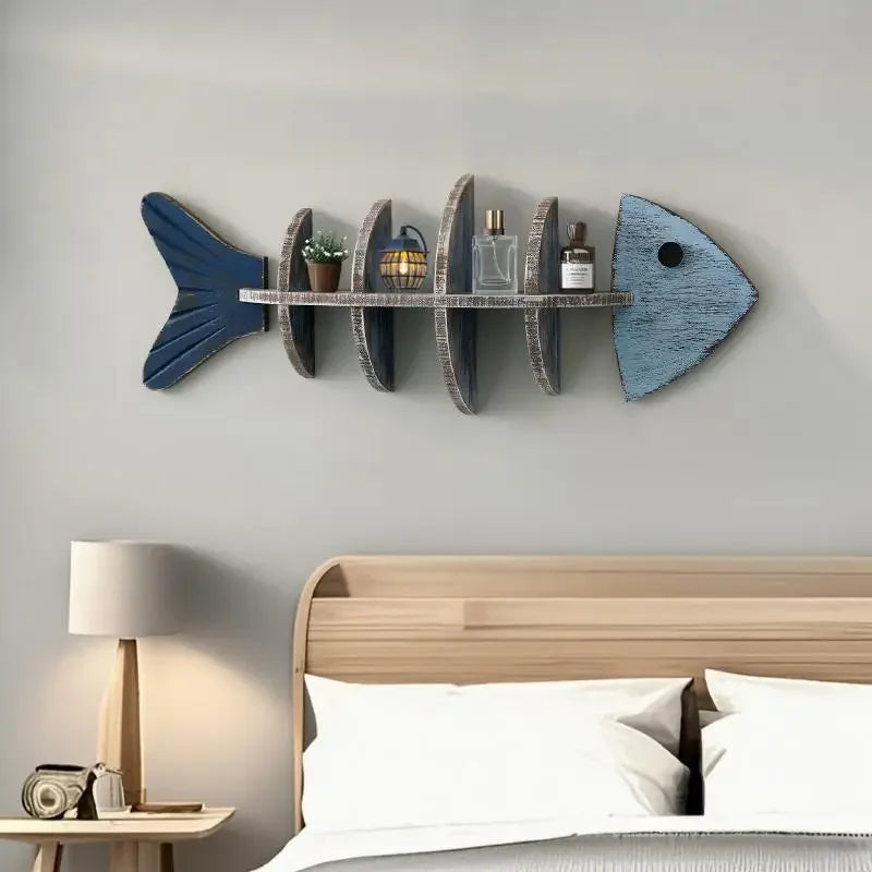 One fish-shaped wall shelf with decorative items on a light gray wall.