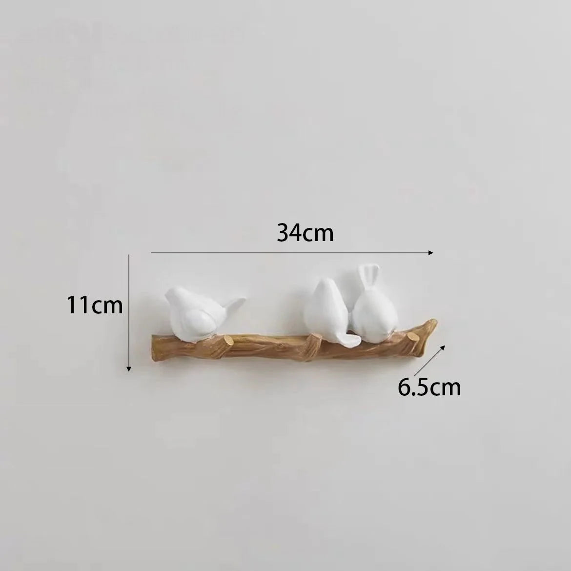 Decorative wall hook with three white birds and measurements on a light gray background