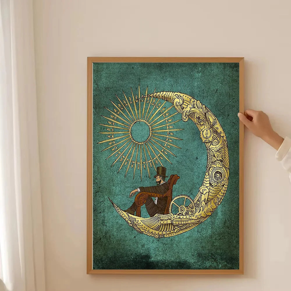Framed artwork of a person sitting on a crescent moon with sun design, held by a hand against a beige wall.