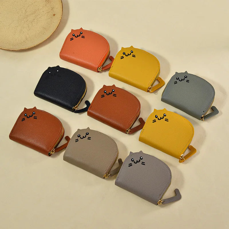 Collection of small purses with cat faces in various colors on a beige background