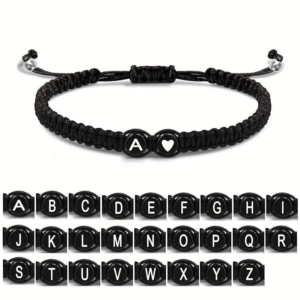 Black braided bracelet with letter 'A' charm on a white background