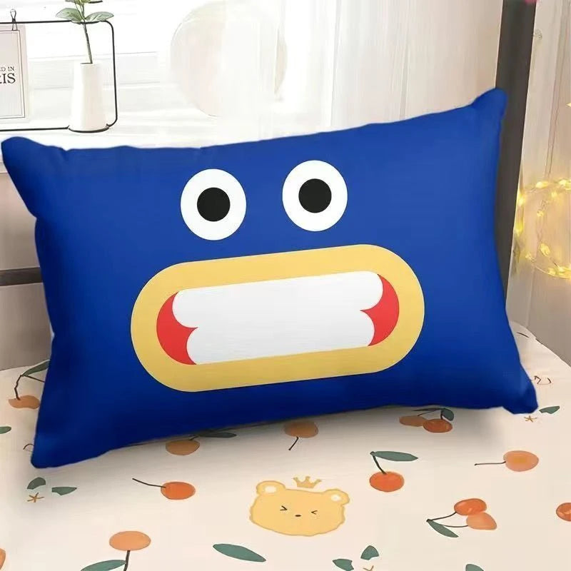 Blue pillow with cartoon face design on a bed with a floral pattern