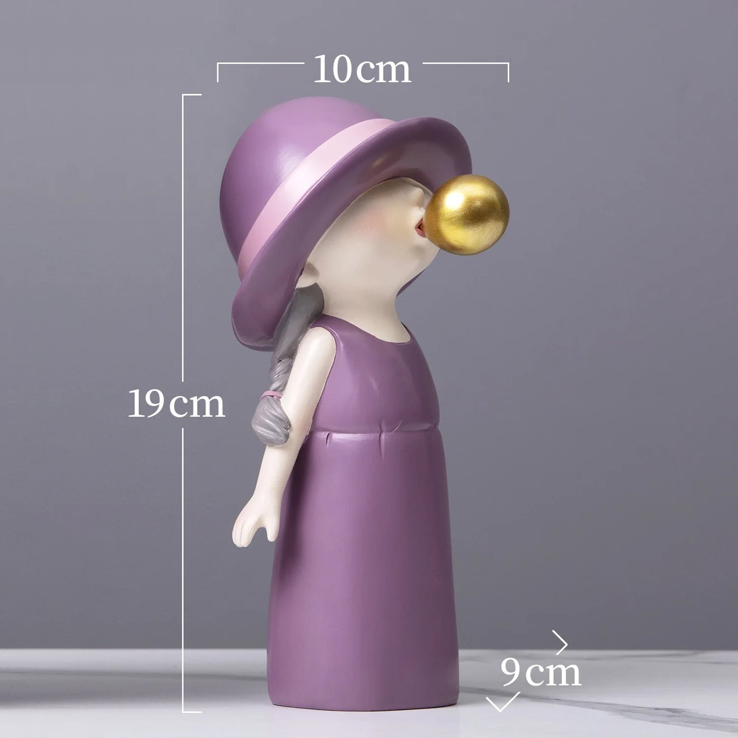 Decorative figurine with a purple hat and dress, gold bubble, and measurements on a gray background