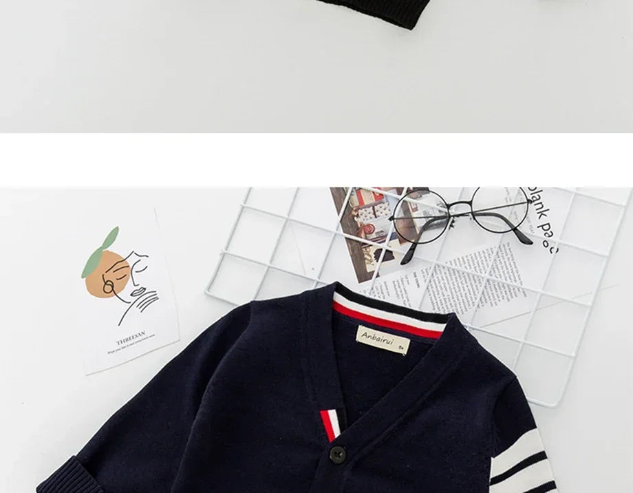 Navy cardigan with striped sleeves on a white surface
