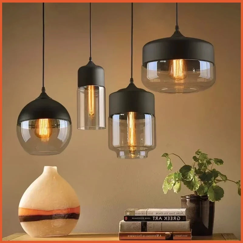 modern glass pendant lights hanging above a kitchen counter in a Nordic style