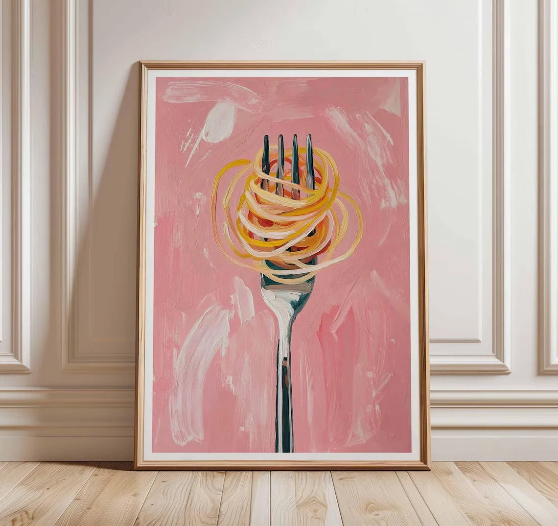 Framed artwork of a fork with spaghetti on a pink background, displayed on a wall.