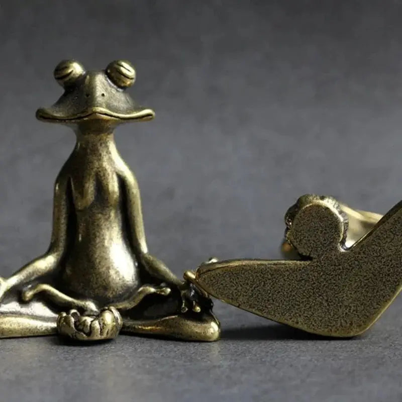 Bronze sculpture of a dog and a bird on a gray background
