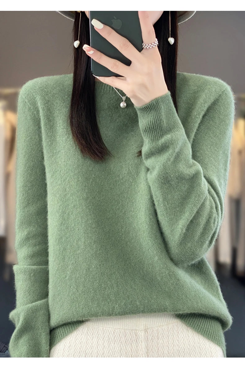 Person wearing a green sweater with a blurred background