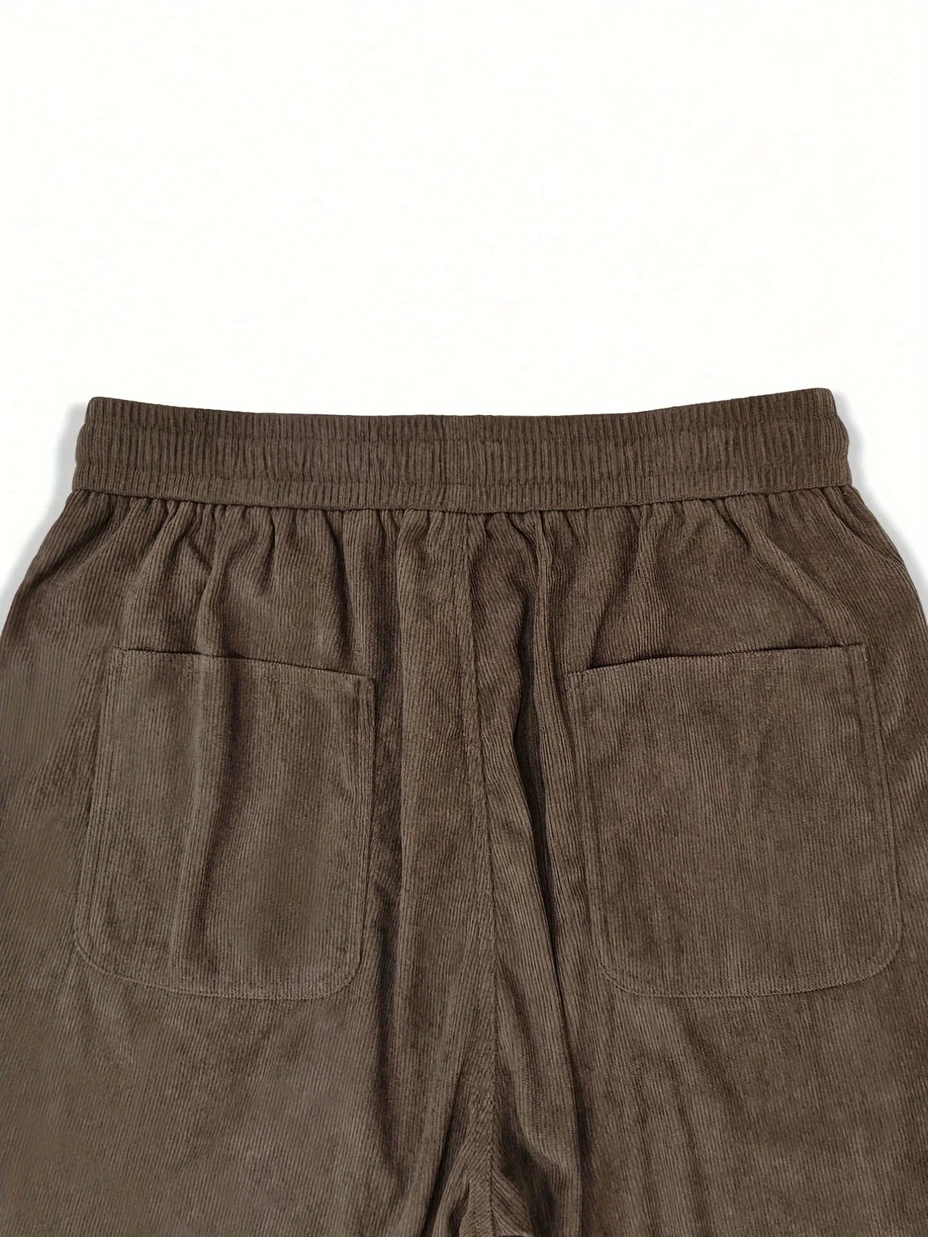 Brown corduroy pants with two front pockets on a white background
