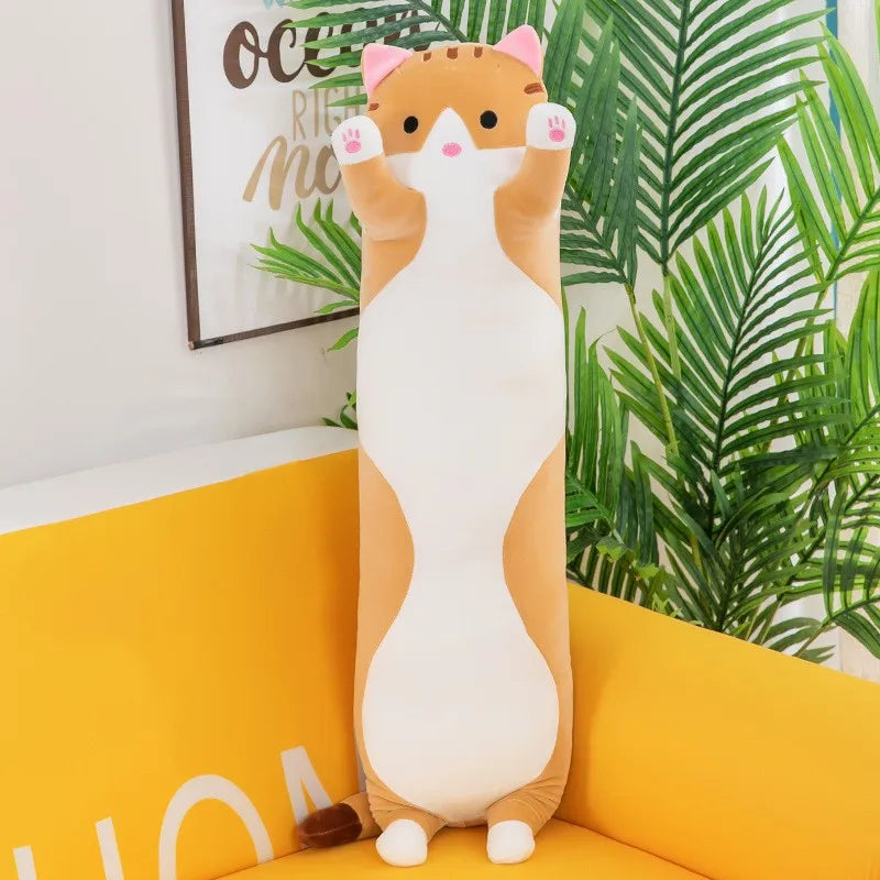 Cat-shaped plush pillow on a yellow couch with plants in the background