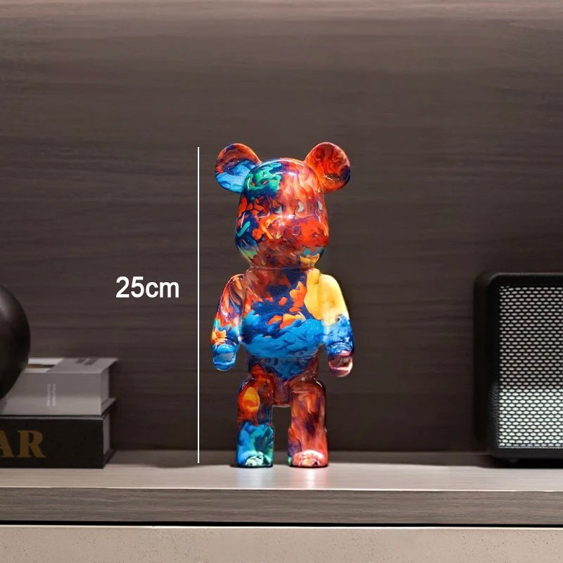 A colorful bear-shaped collectible figure stands on a shelf against a dark wood background, with a white measurement overlay reading 25cm.
