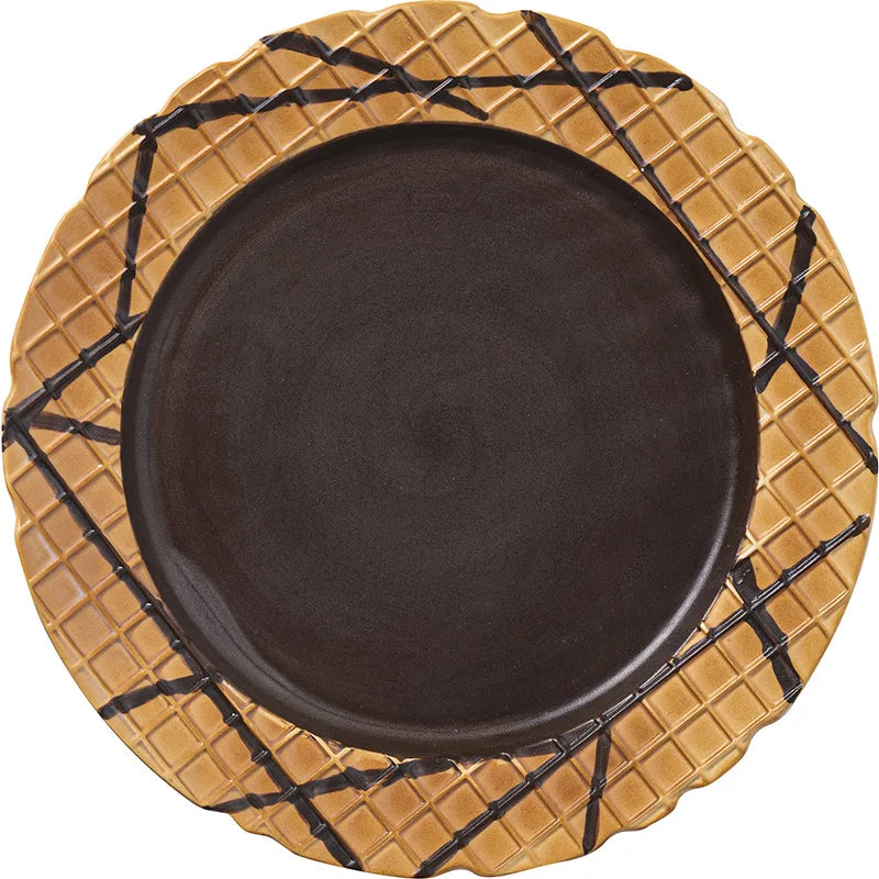 Black plate with a woven gold rim on a white background