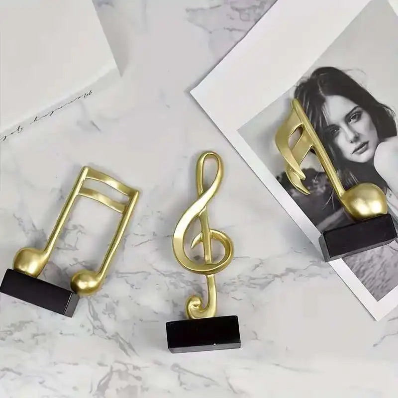 Set of three modern resin musical note sculptures with black bases displayed as contemporary home décor, available in black, white and gold finishes.