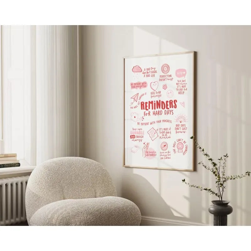 Framed artwork with motivational text in a room with a textured chair and plant.