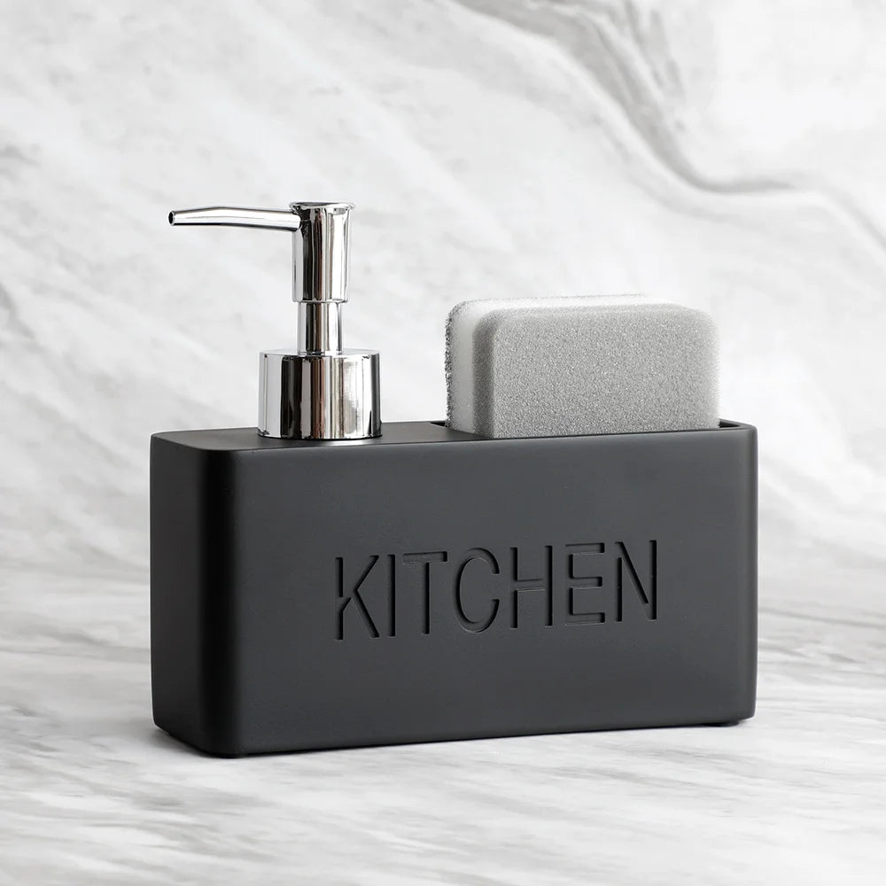 Black kitchen sink caddy with soap dispenser and sponge on a marble countertop