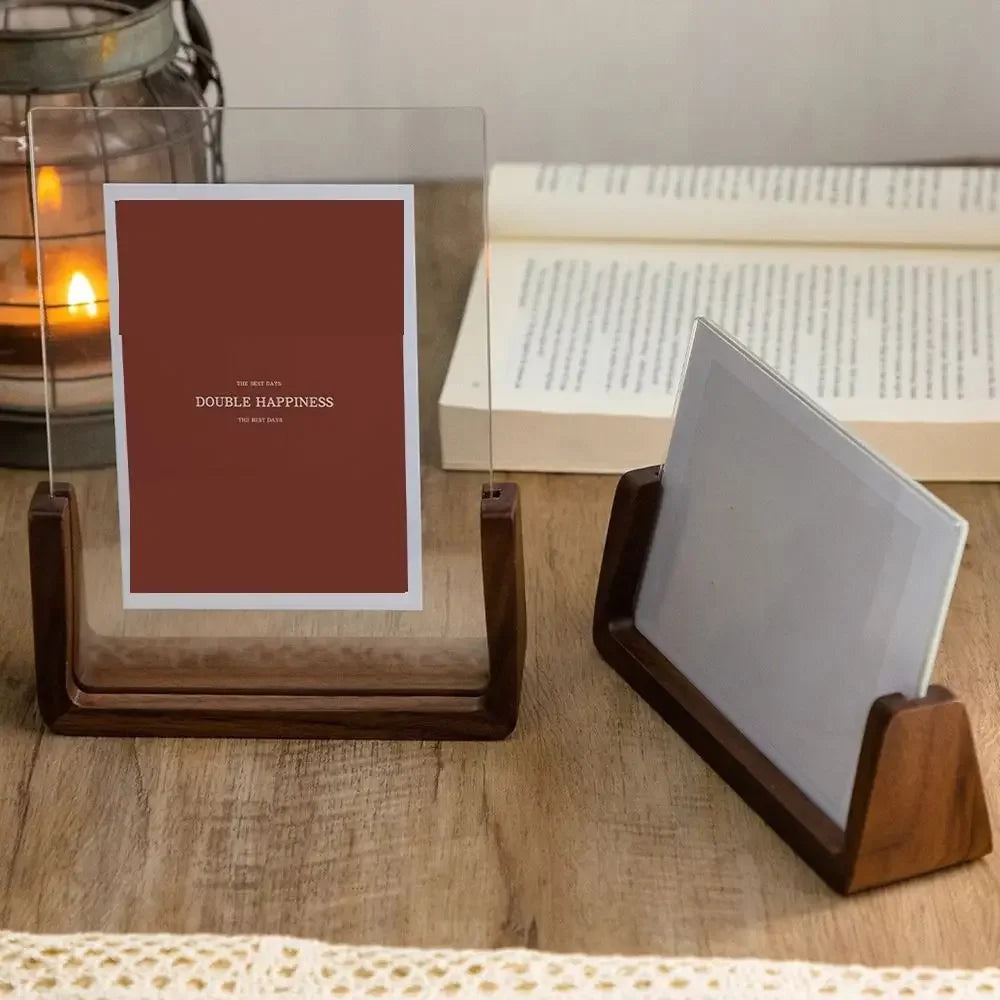 Wooden Photo holder with a red card and white card on a wooden surface with a candle and book in the background.