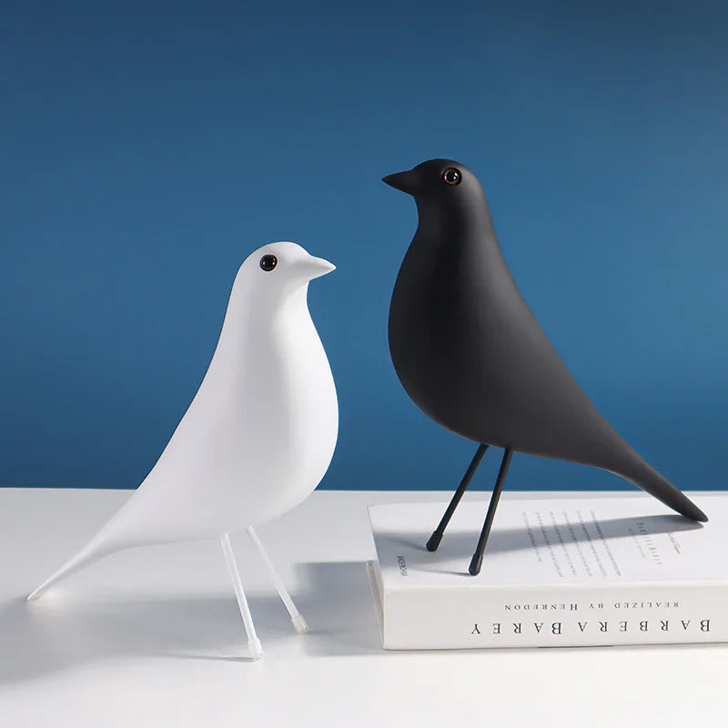 White and black bird sculptures on a blue background