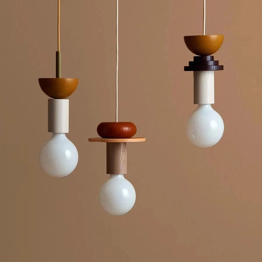 Three hanging pendant lights with wooden and ceramic designs on a brown background
