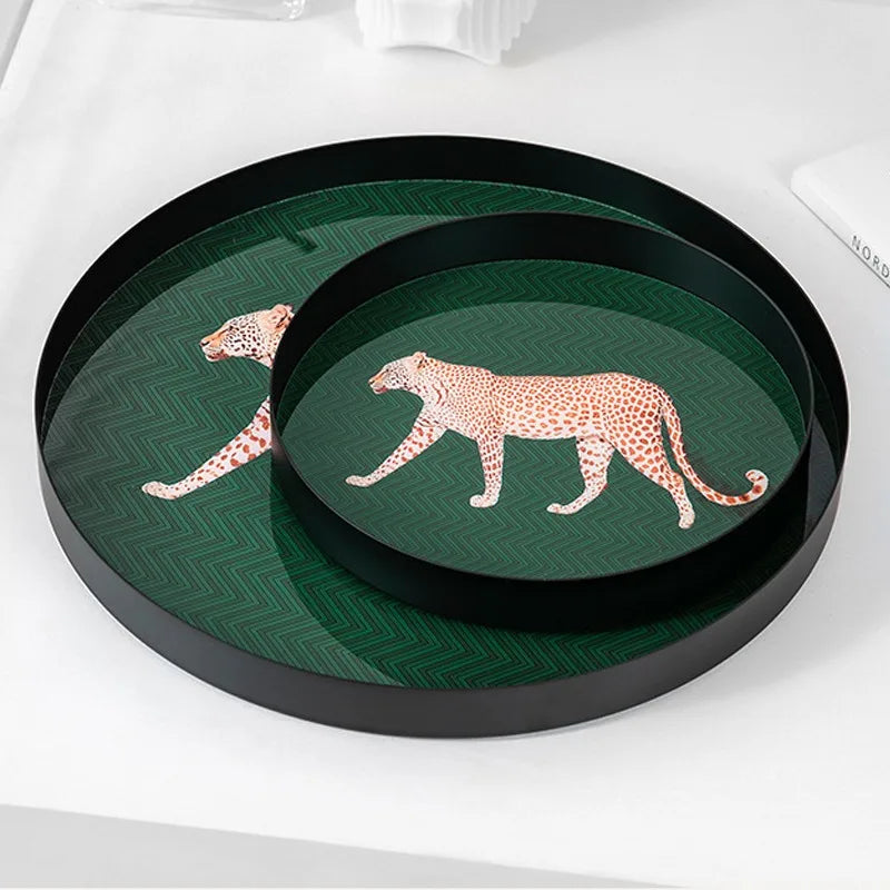 Two decorative trays with leopard designs on a green background, one inside the other.