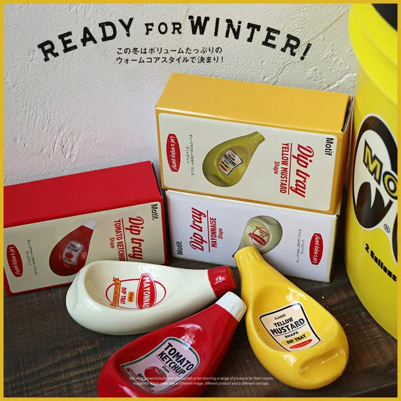 A styled product display of miniature toy food containers and their boxes, designed to look like real mustard, ketchup, and mayonnaise bottles, with 'READY FOR WINTER!' text on a wall background.