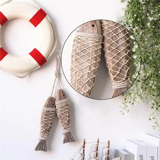 Decorative fish and life buoy on a wall with a close-up of fishing net.