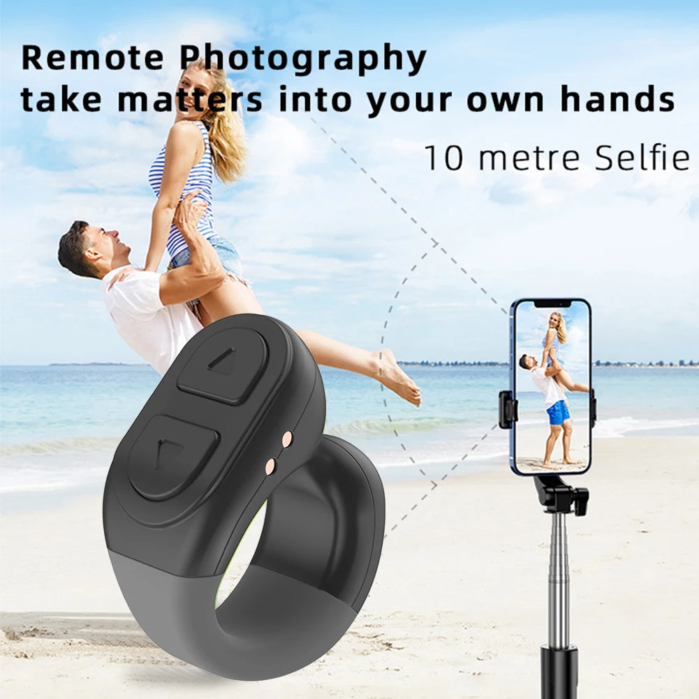 Black remote control device for photography with a beach scene in the background