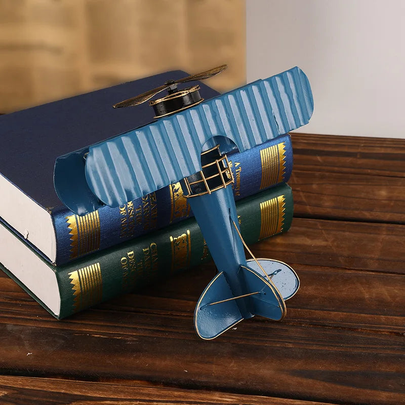 Vintage metal airplane ornament with a detailed retro aircraft design, available in red, yellow and blue for desk or shelf display.