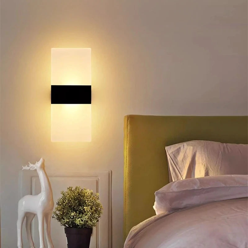 USB rechargeable touch sensor LED wall light with acrylic shade mounted above a bed.
