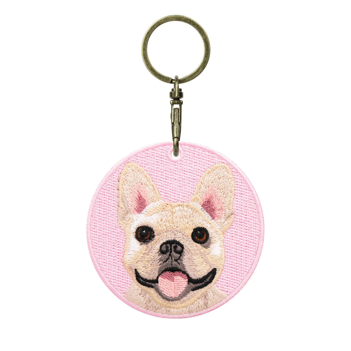 Keychain with a dog's face design on a pink background